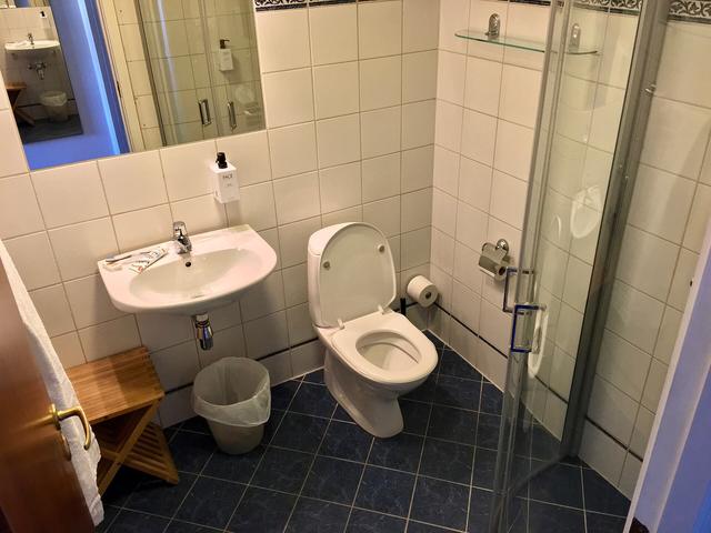 Glass shower screen in a tiled bathroom