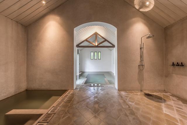 Bright bathroom with a large walk in shower and stone floor
