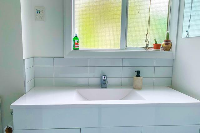 Bright room with a white vanity and window